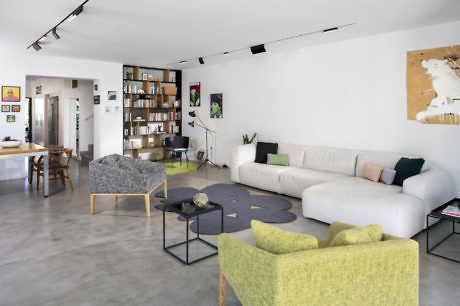 Chic living space with a minimalist design, polished concrete floors, and vibrant accent