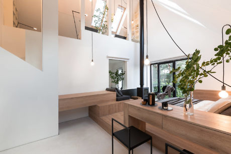 Bright, minimalist interior with wooden fixtures and large windows.