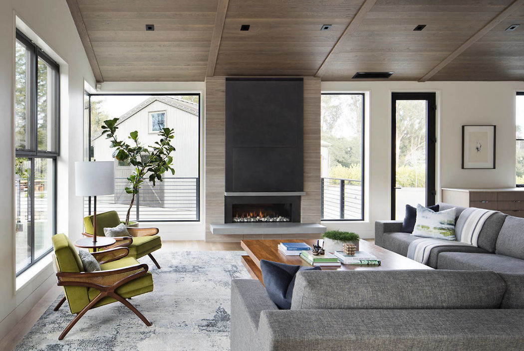 Contemporary living room with fireplace and wood-paneled ceiling.