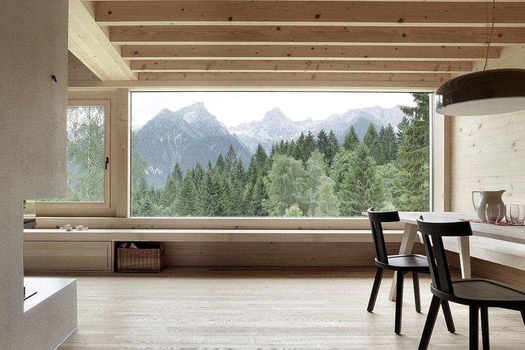 Scandinavian-style room with large window overlooking mountains.