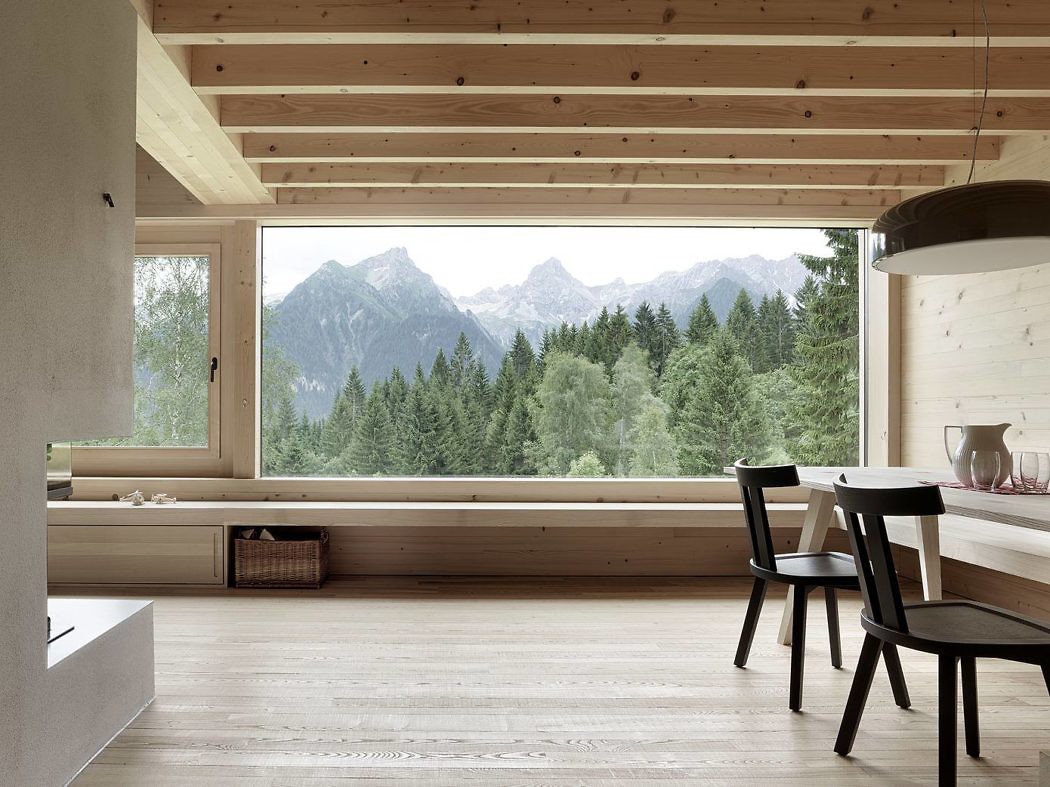 Scandinavian-style room with large window overlooking mountains.