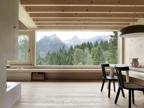 Scandinavian-style room with large window overlooking mountains.