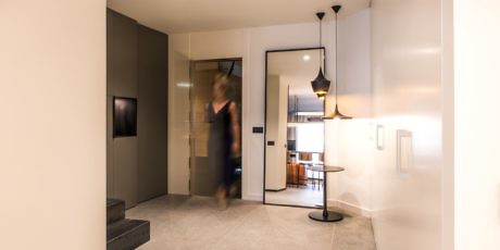 Modern hallway with a blurred person walking through.