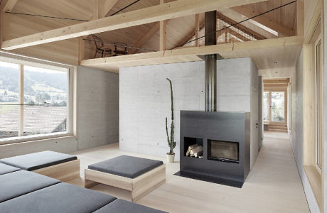 Scandinavian-style interior with minimalist fireplace and exposed wooden beams.