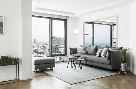Contemporary living room with city view and minimalist decor.