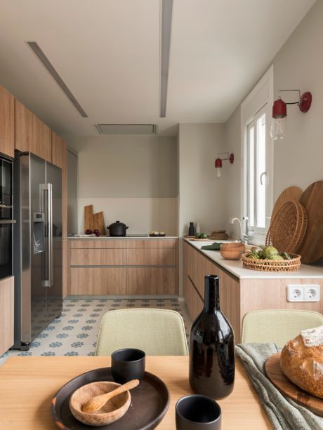 Contemporary kitchen with wood cabinets and patterned floor tiles.