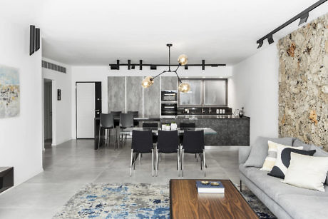 Contemporary interior with stone accent wall and sleek furnishings.