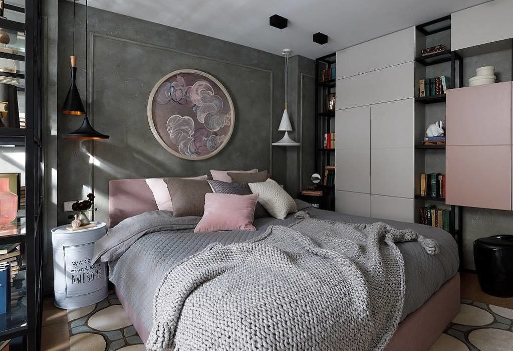 Contemporary bedroom with grey walls, plush bedding, and built-in bookshelves