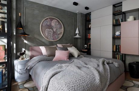 Contemporary bedroom with grey walls, plush bedding, and built-in bookshelves