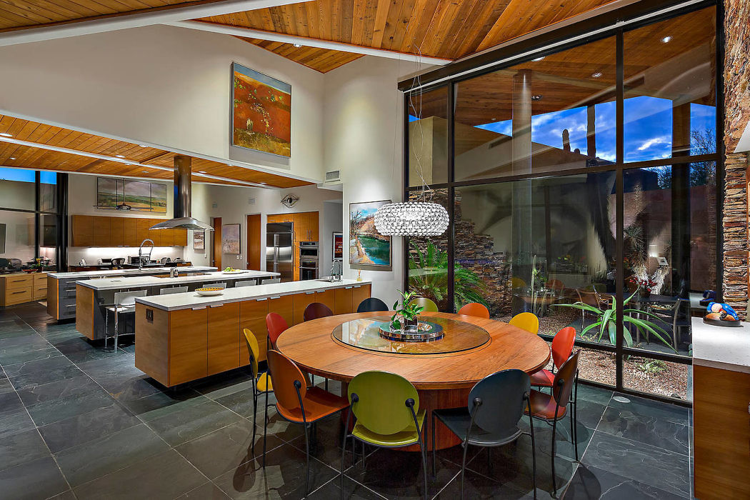 Contemporary kitchen with wooden accents and large glass windows.