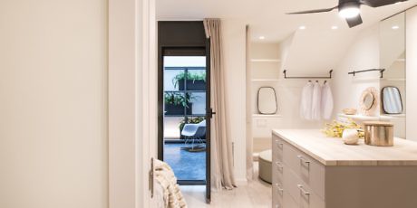 Elegant bathroom with neutral tones and dual vanity sinks.