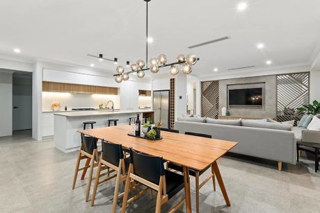 Contemporary open-plan living space with kitchen island and stylish lighting.