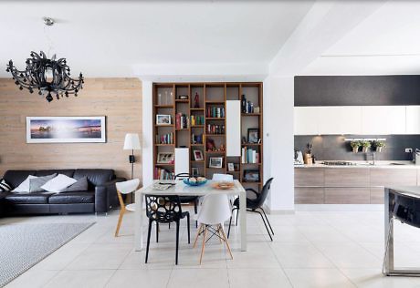 Modern living room with dining area and adjacent kitchen.