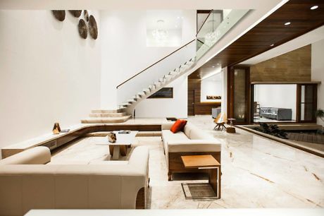 Modern living room interior with staircase and open-plan design.