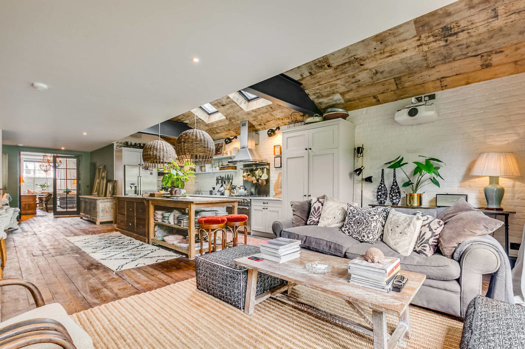 Stylish open-plan living space with rustic wooden beams and chic decor.