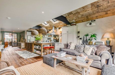 Stylish open-plan living space with rustic wooden beams and chic decor.