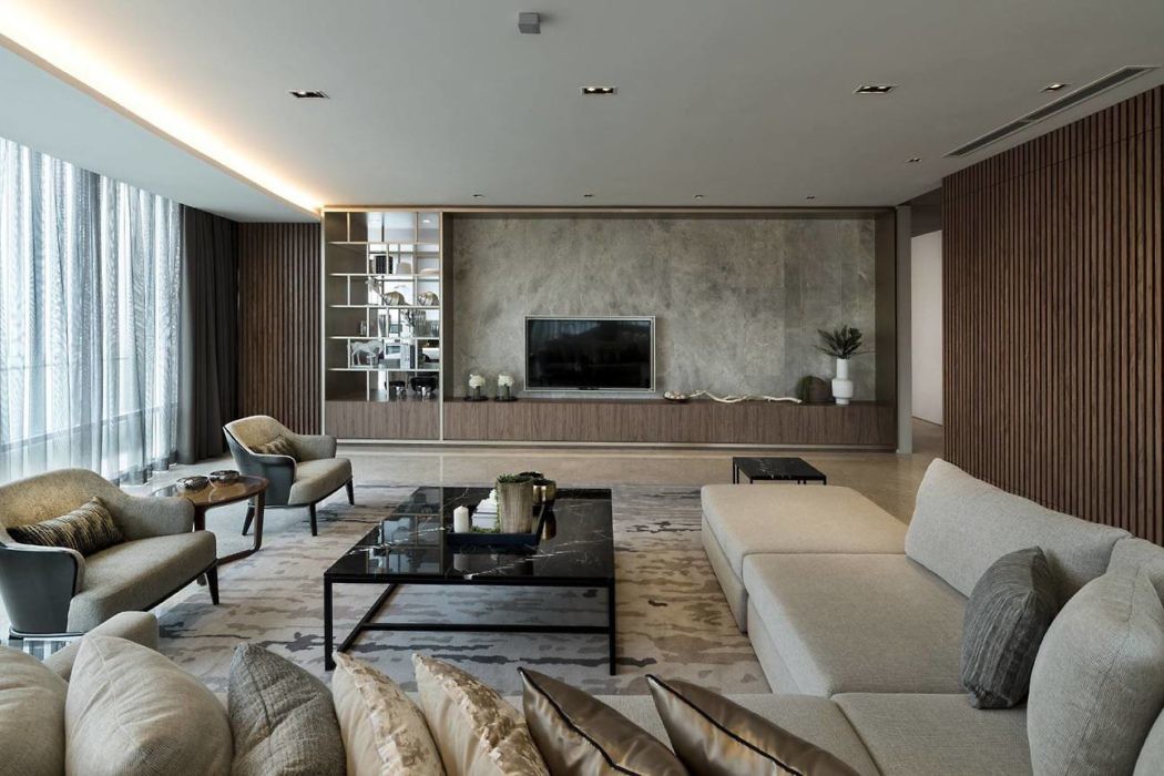 Modern living room with neutral tones, sleek furniture, and wooden accents.