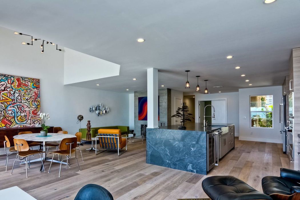 Spacious open-plan interior with eclectic furnishings and art.
