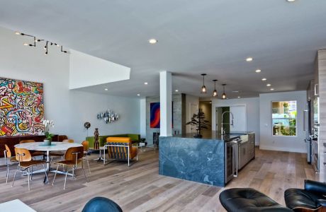 Spacious open-plan interior with eclectic furnishings and art.