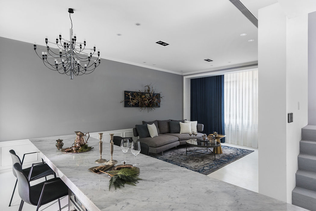 Chic living room with marble floor, gray walls, and an eclectic chandelier