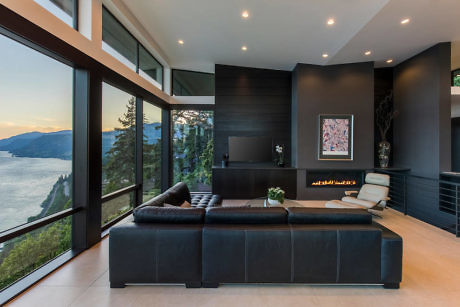 Modern living room with large windows overlooking a scenic view.