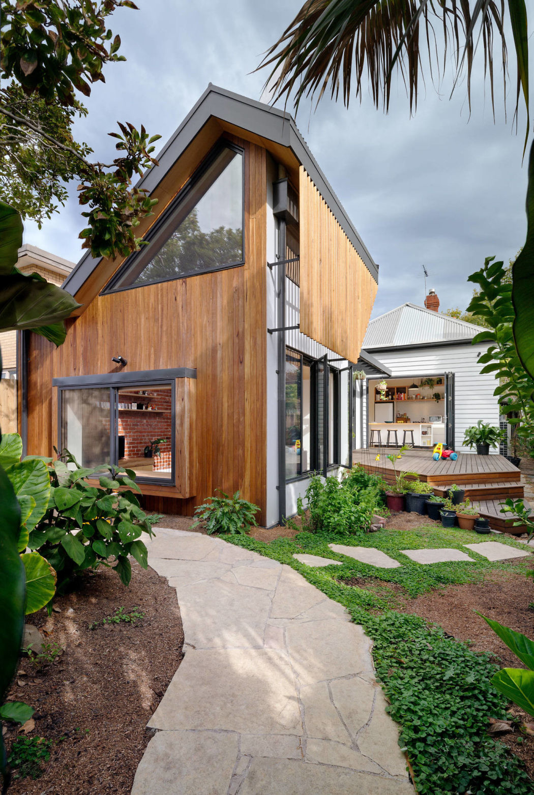 Modern wooden home extension with garden path.