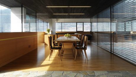 Contemporary dining space with glass walls and wooden accents.