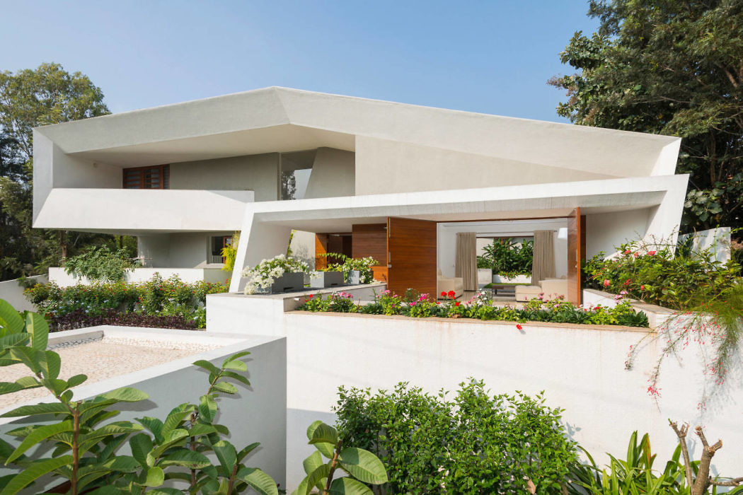 Contemporary house with geometric design and lush garden.