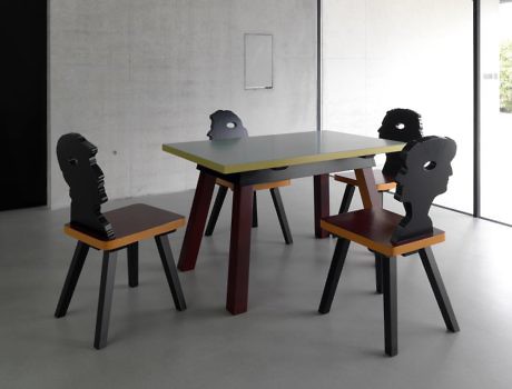 Minimalist room with unique chairs designed as human silhouettes around a table.