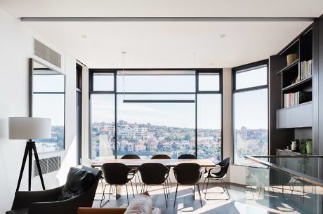 Sleek interior with floor-to-ceiling windows and city view.
