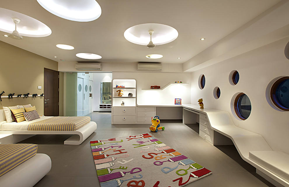 Modern children's room with circular windows, white furniture, and colorful rug.