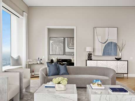 Spacious, minimalist living room with marble coffee table, abstract artwork, and geometric mirror.