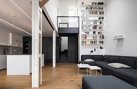 Attic Apartment with a Black Box by Komon Architekti
