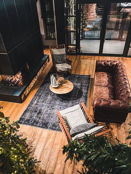 Cozy living room with a fireplace, leather sofa, and wood accents.
