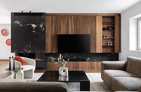 Minimalist living room with sleek wood paneling, black marble accents, and built-in shelving.