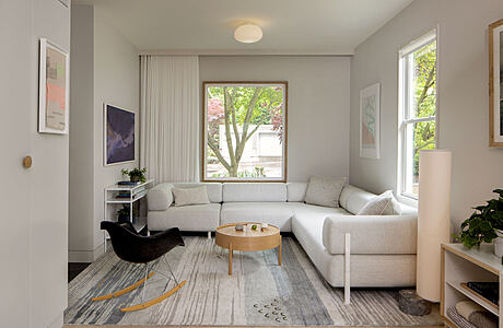 Contemporary living room with neutral tones and ample natural light.