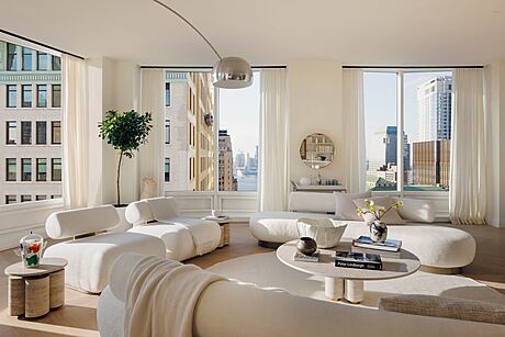 Spacious, modern living room with floor-to-ceiling windows overlooking the city skyline.