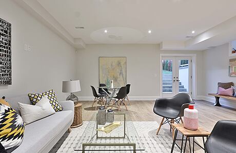 Warm, inviting living space with modern furnishings, artwork, and textured rug.