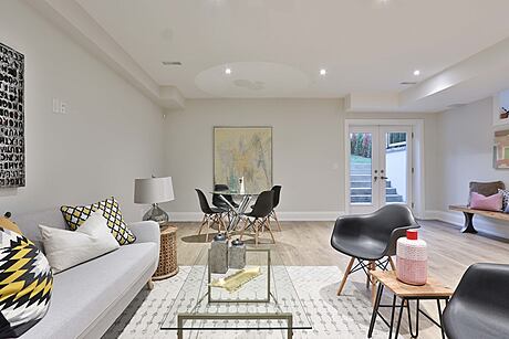 Warm, inviting living space with modern furnishings, artwork, and textured rug.