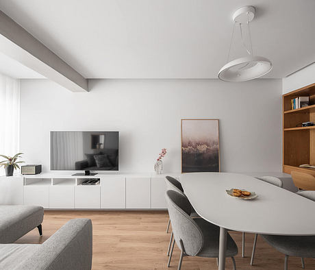 Minimalist living room with white walls, modern furniture, and wood accents.