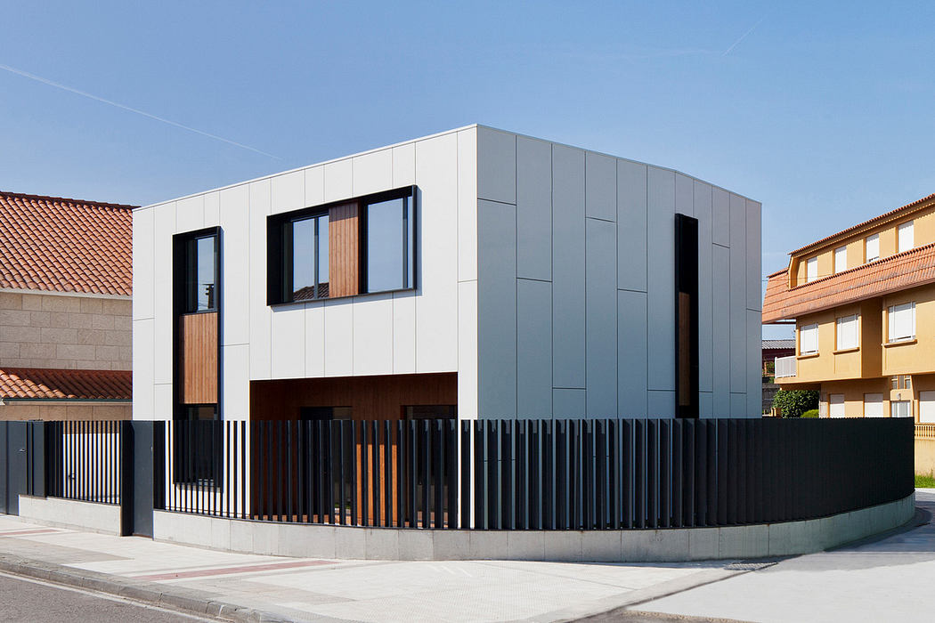 Modern two-toned house with geometric design and wooden accents.
