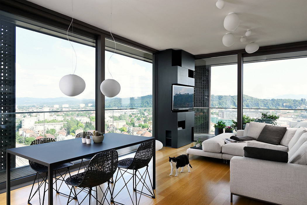 Modern living room with city view, sleek furniture, and a cat.