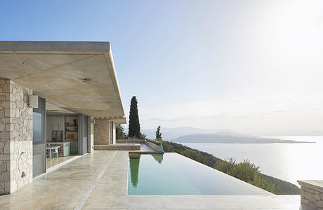 Modern seaside villa with infinity pool and expansive view.