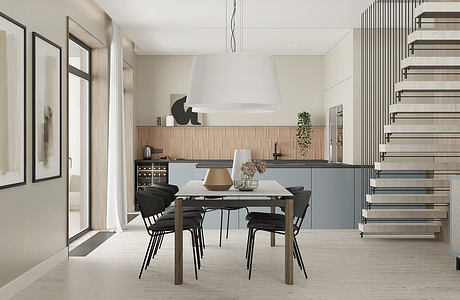 Modern kitchen with dining area and open staircase in neutral tones.