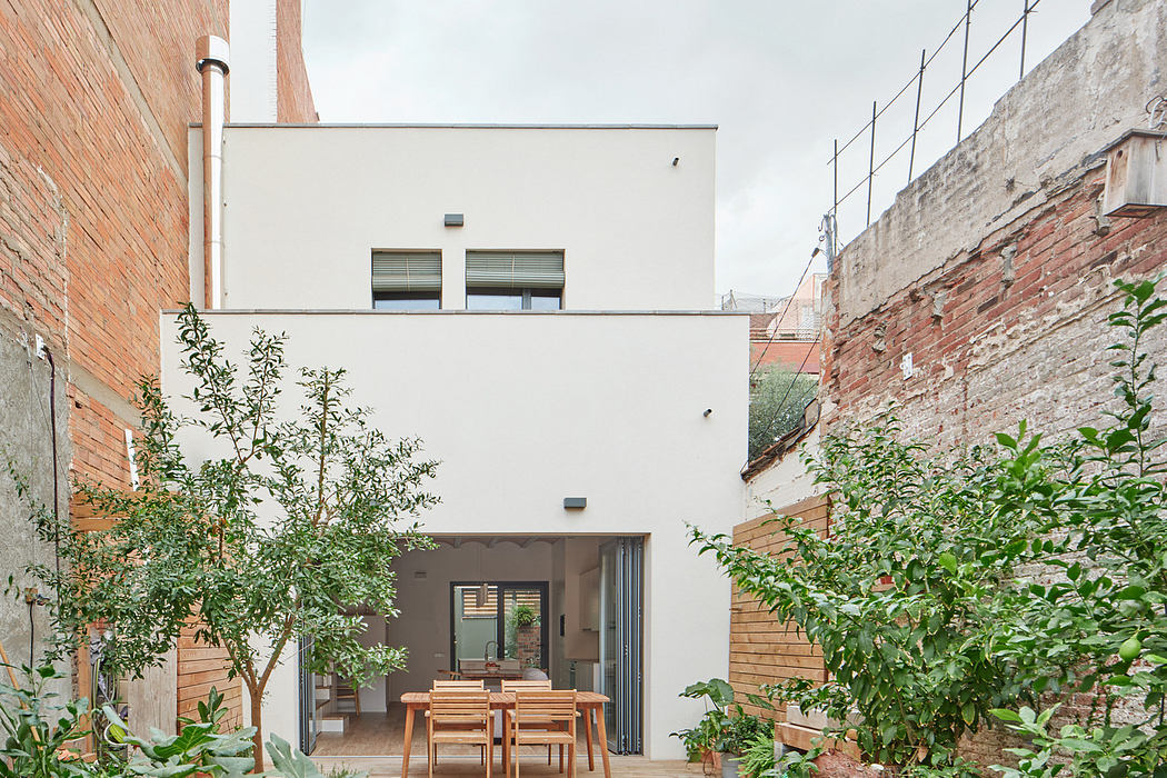 Urban courtyard with garden and contemporary home exterior.