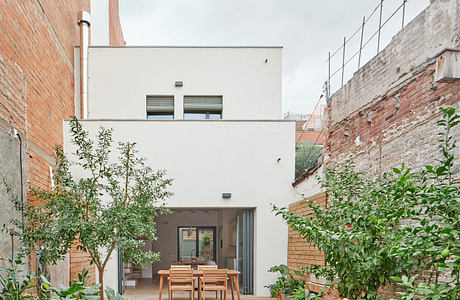 Urban courtyard with garden and contemporary home exterior.