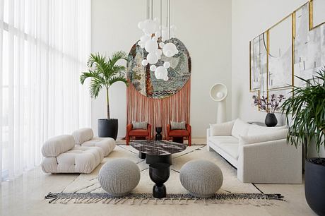 Modern living room with eclectic furniture and artistic lighting fixture.