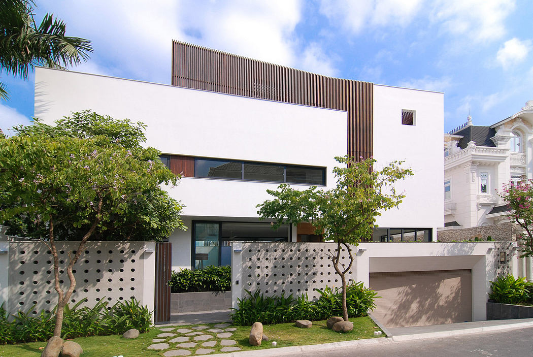 Modern two-story house with white facade and wooden accents.