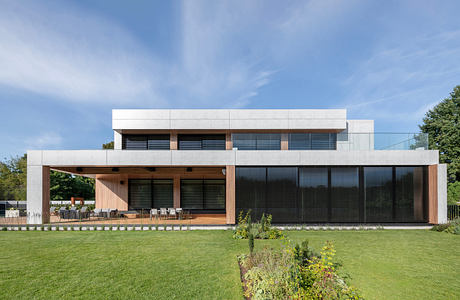 Modern two-story house with large windows and a flat roof.