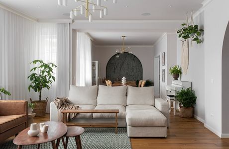 Elegant living room with modern furniture and green accents.